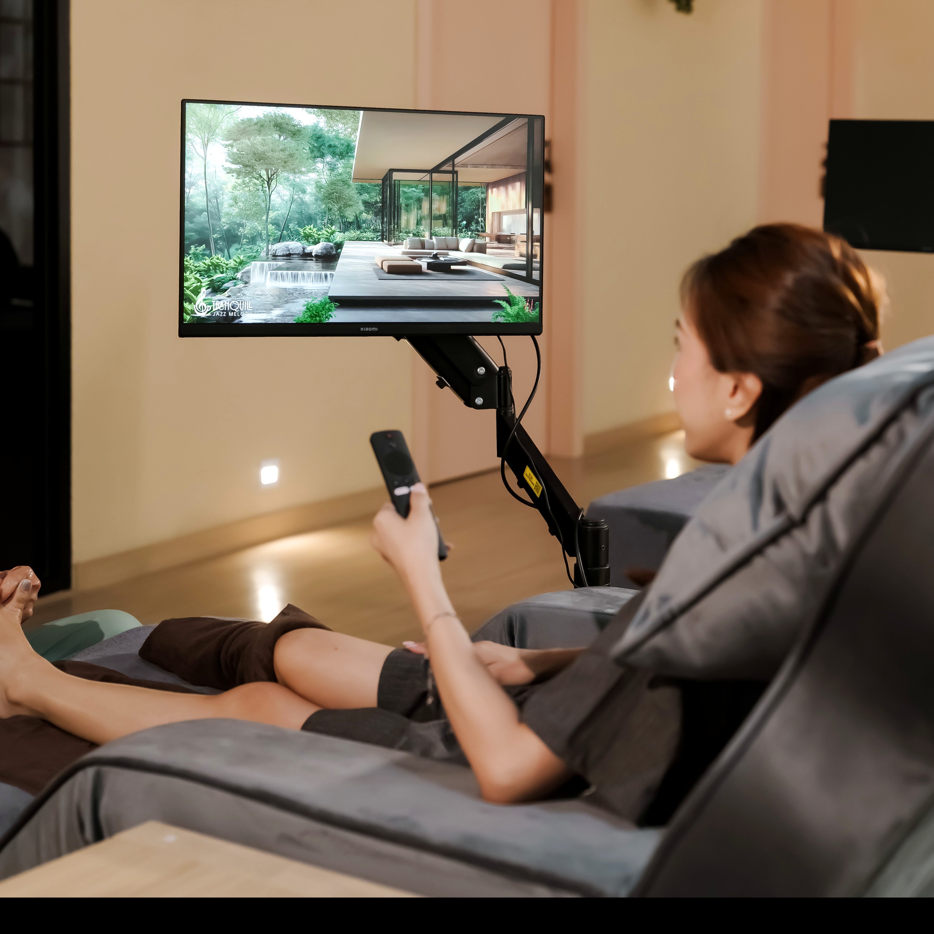 Guest reclining in a premium massage chair, streaming entertainment on a personal screen